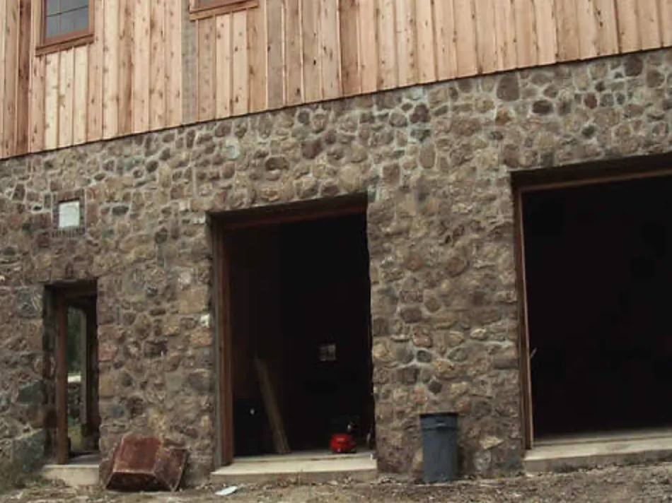 Fieldstone masonry on the lower level of a bank barn