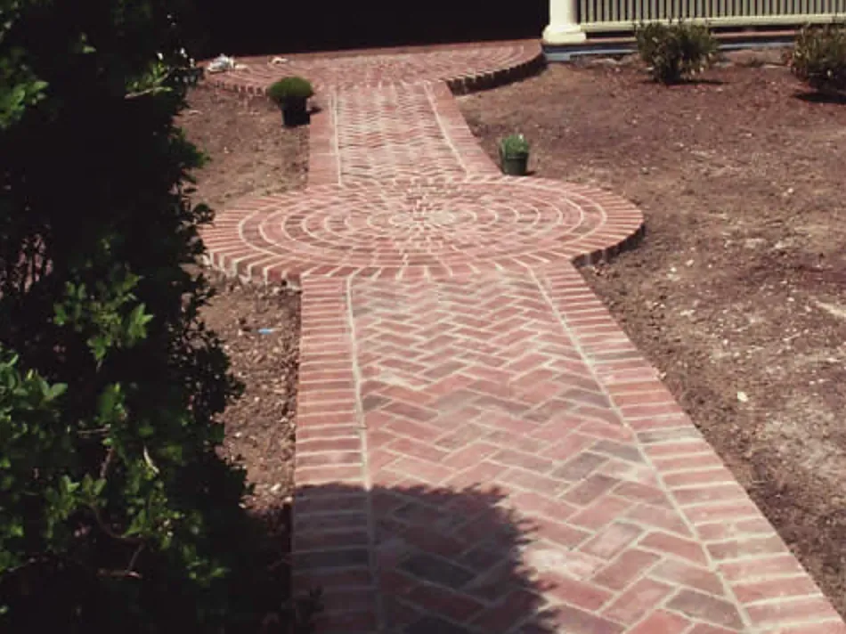 Herringbone brick walk with a soldier-course border and circular brick medallion