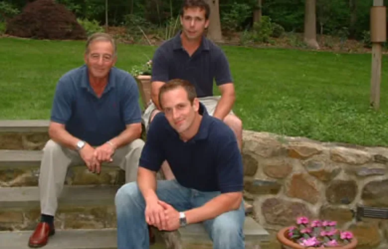 Vince, Scott and Todd Cappelli seated on stone steps